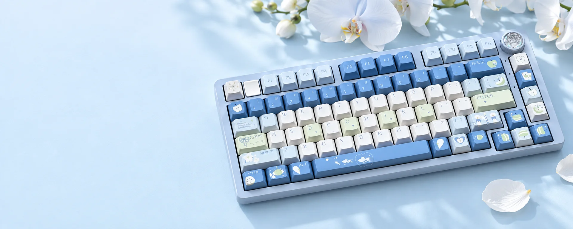 Blue Apple keycaps in soft blue, green and ivory with white orchids