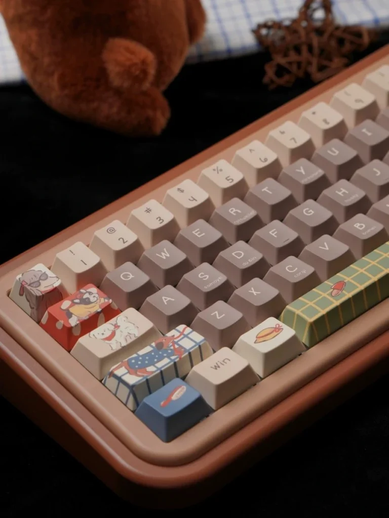 Left-side detail of Playful Pups keycaps with illustrated dogs and plaid novelty keys