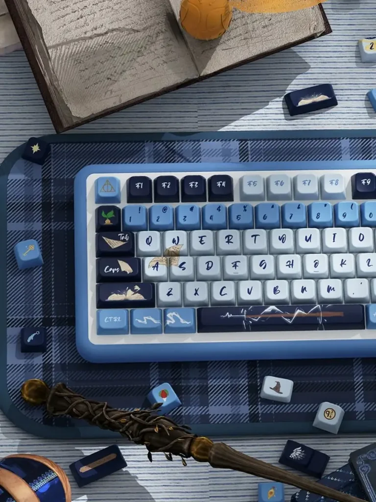 Left-side detail of Ravenclaw keycaps with book, quill and wand designs