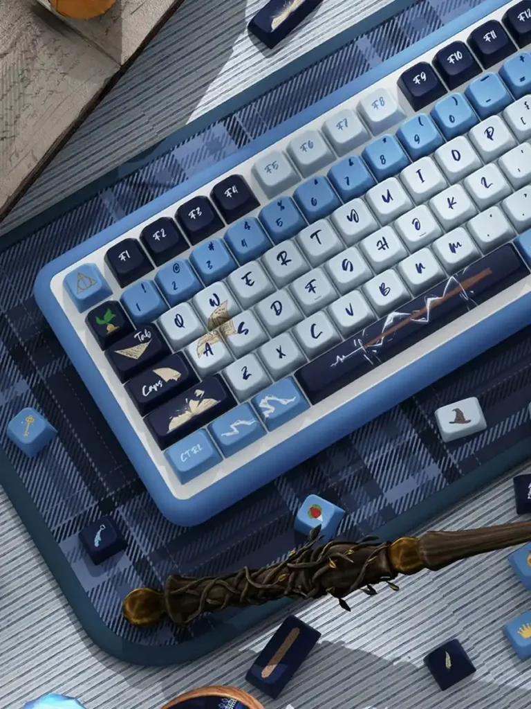 Angled view of Ravenclaw blue and ivory keycaps on a plaid desk mat