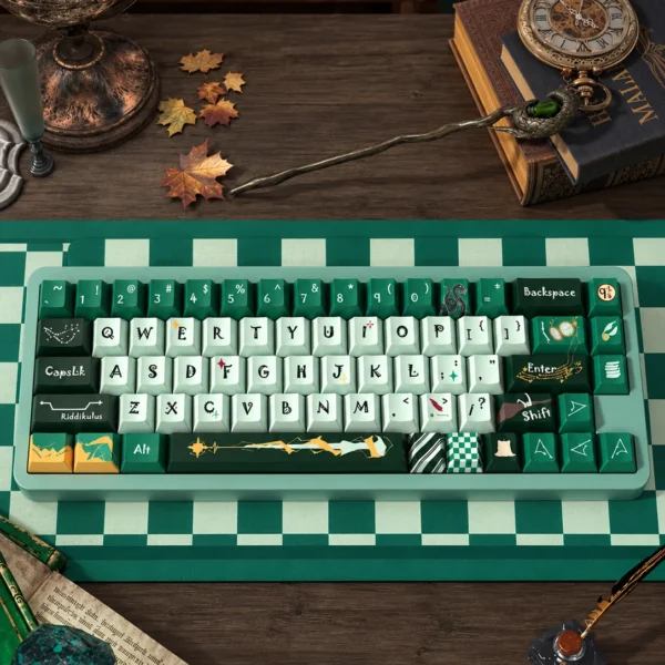 Slytherin 158-key keycaps in emerald, mint and gold, centered on a green checkerboard desk mat